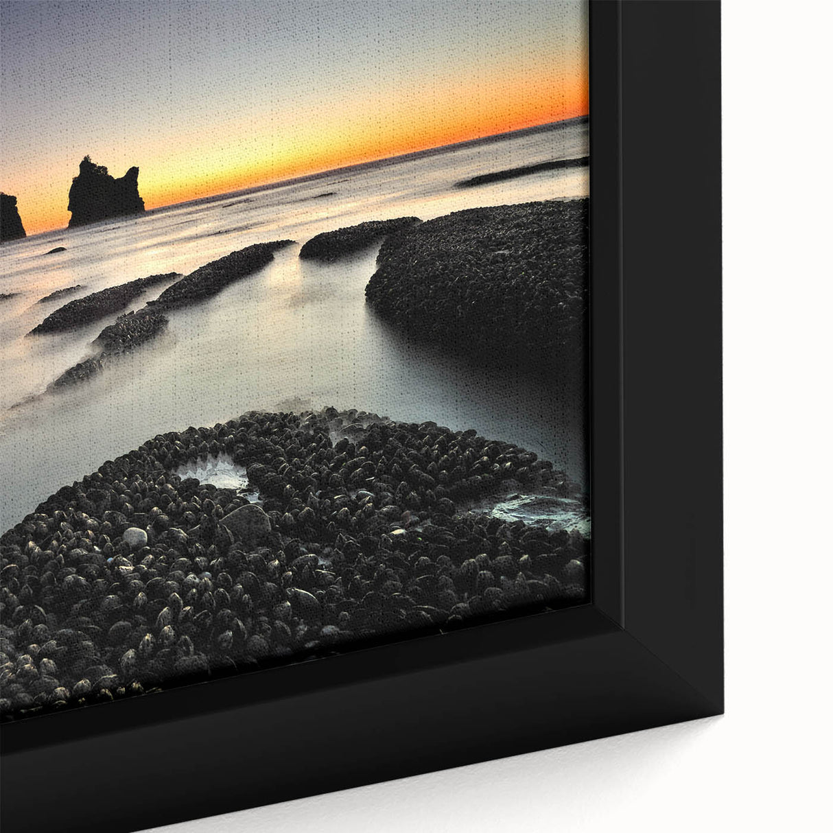Black wall art depicting the rugged New Zealand West Coast in vibrant colors on a textured, framed canvas.