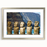Textured art depicting Easter Island statues in muted earth tones on a framed silver mat, ideal for bedroom art.