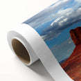 Art deco poster of Monument Valley in Arizona on rolled canvas, featuring earthy red and orange tones.