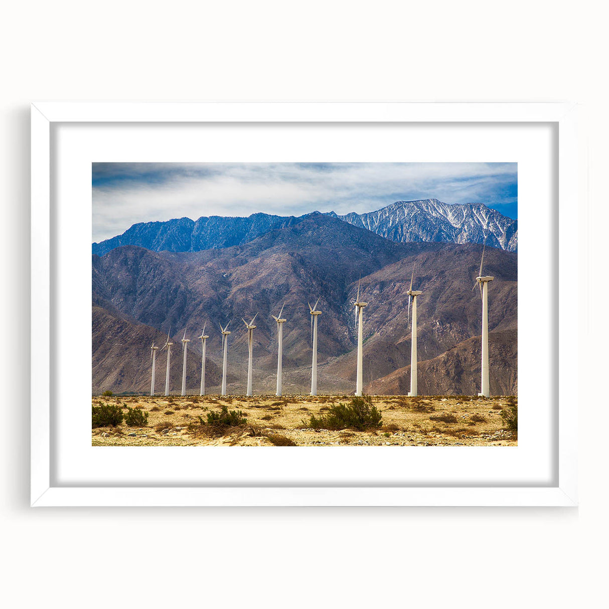 Abstract art print of Palm Springs with a mix of vibrant and muted tones on a framed white mat.
