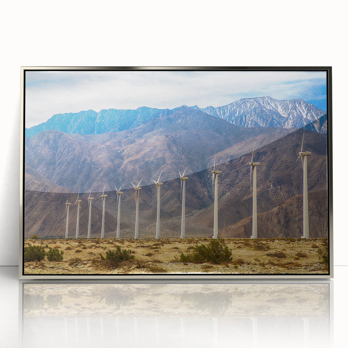 Mid-century modernist art depicting Palm Springs scenery in muted pastel tones on a silver-framed acrylic print.