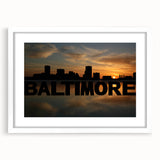 Abstract art print of Baltimore skyline in muted gray and blue tones, framed with a white mat.