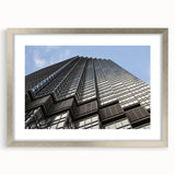 Textured abstract art print of Minneapolis skyline in muted gray and blue tones, framed with a silver mat.