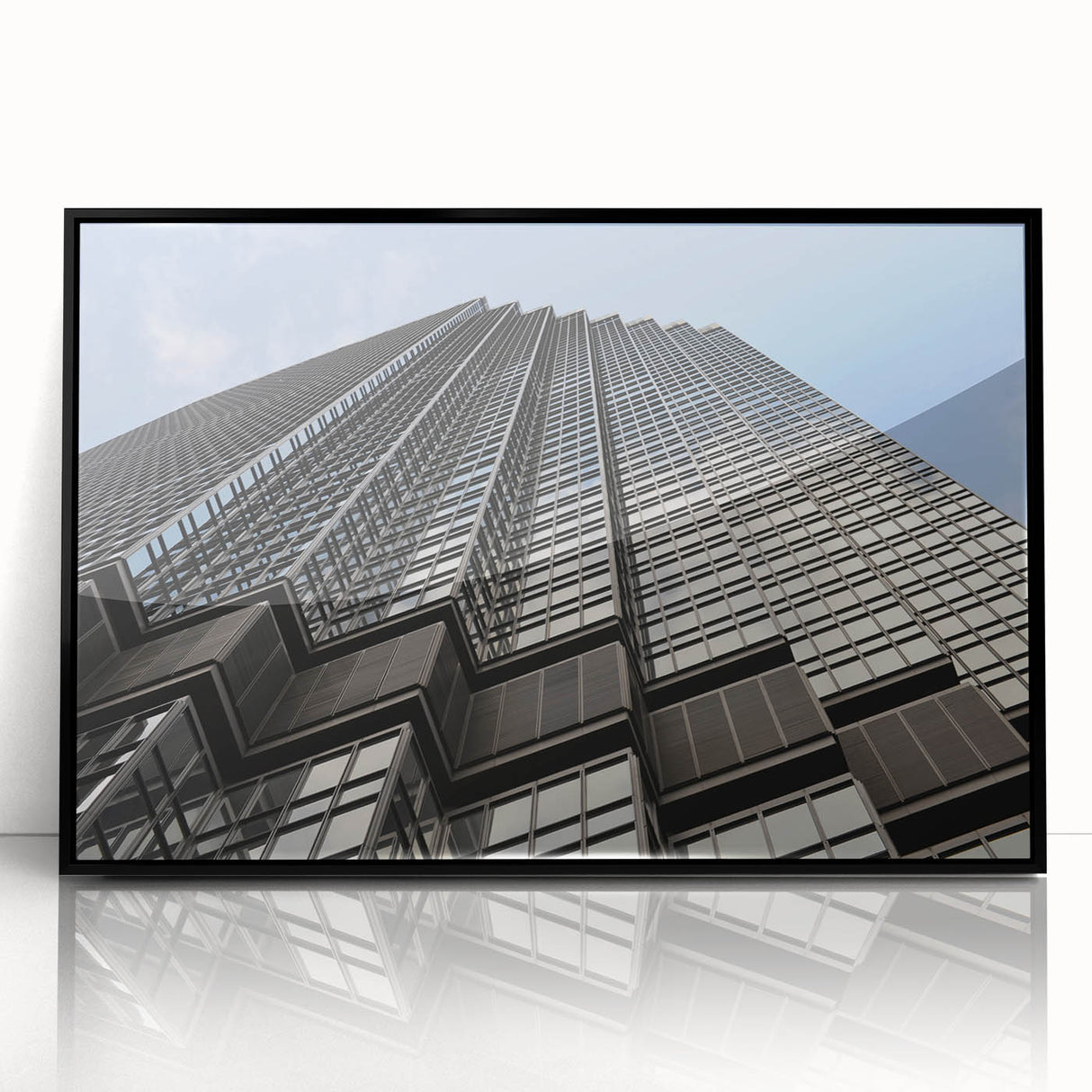 Large abstract wall art depicting the Minneapolis skyline in muted gray and blue tones, framed in black acrylic.