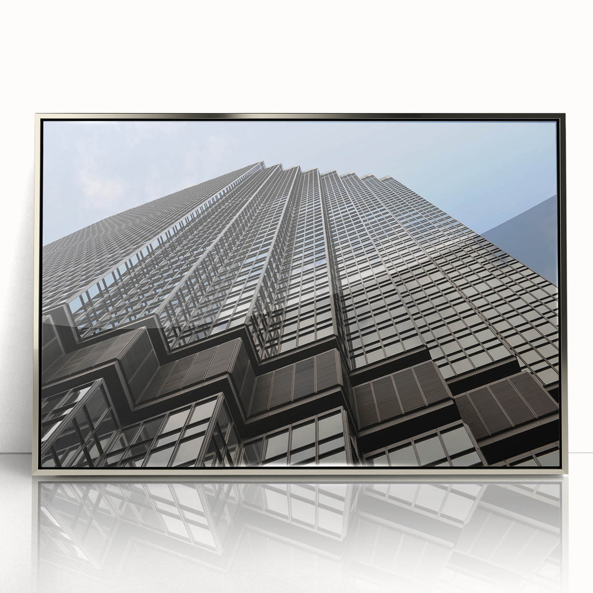 Mid-century modernist art depicting the Minneapolis skyline in muted blue and gray tones, framed in silver acrylic.