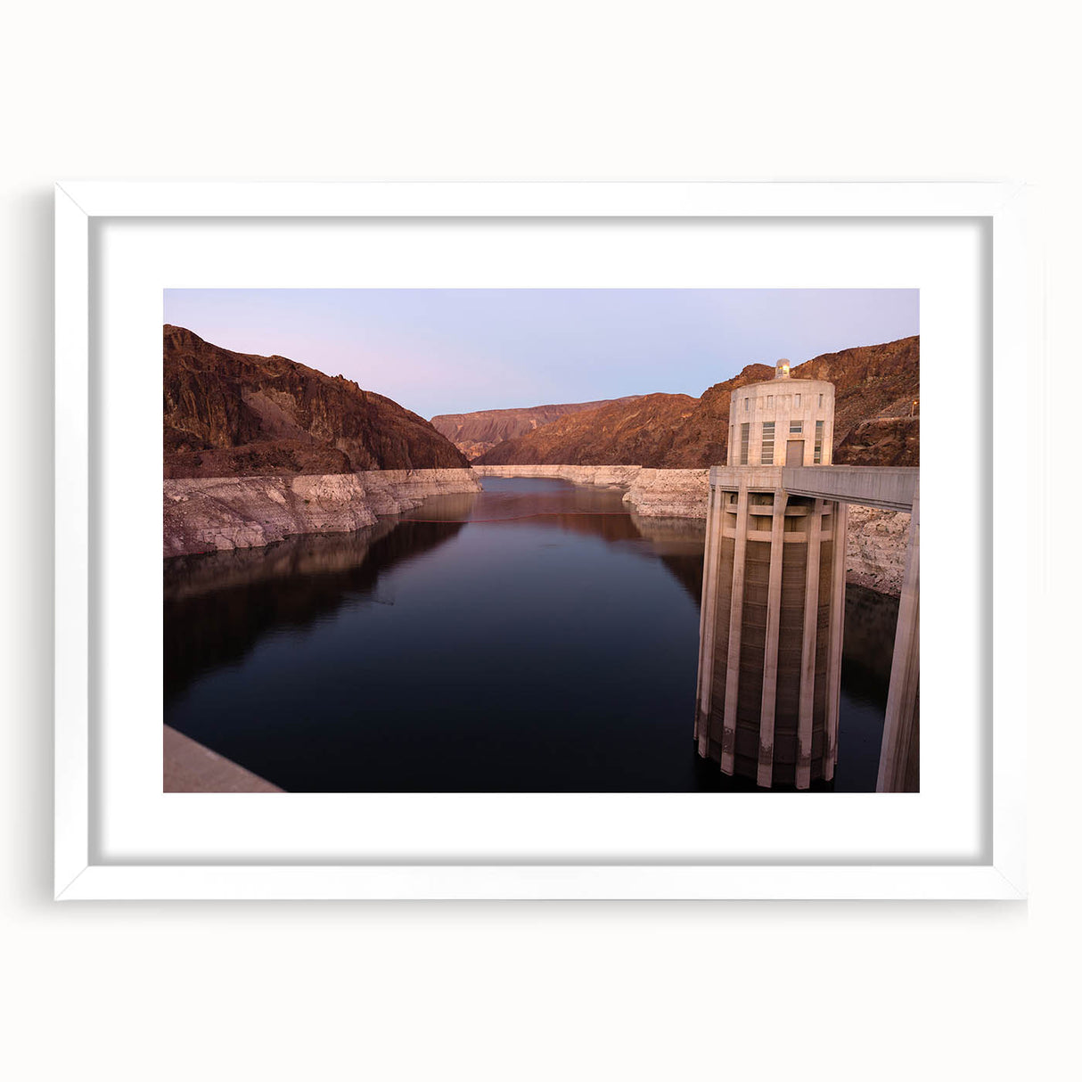 Abstract art print of Hoover Dam in muted gray and blue tones, framed with a white mat.