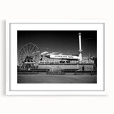 Abstract art print of Coney Island with muted blue and gray tones on a framed white mat, ideal for dining room decor.