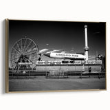 Framed canvas wall art featuring a vintage-style landscape of Coney Island, with a black and gold color scheme.