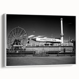 Vintage poster art of Coney Island on a framed canvas, showcasing vibrant colors on a black background.