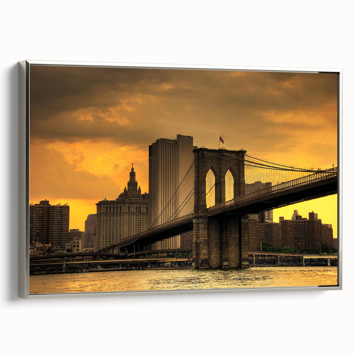 Framed canvas of the Brooklyn Bridge in grayscale with colorful skyline, ideal for living room decor.