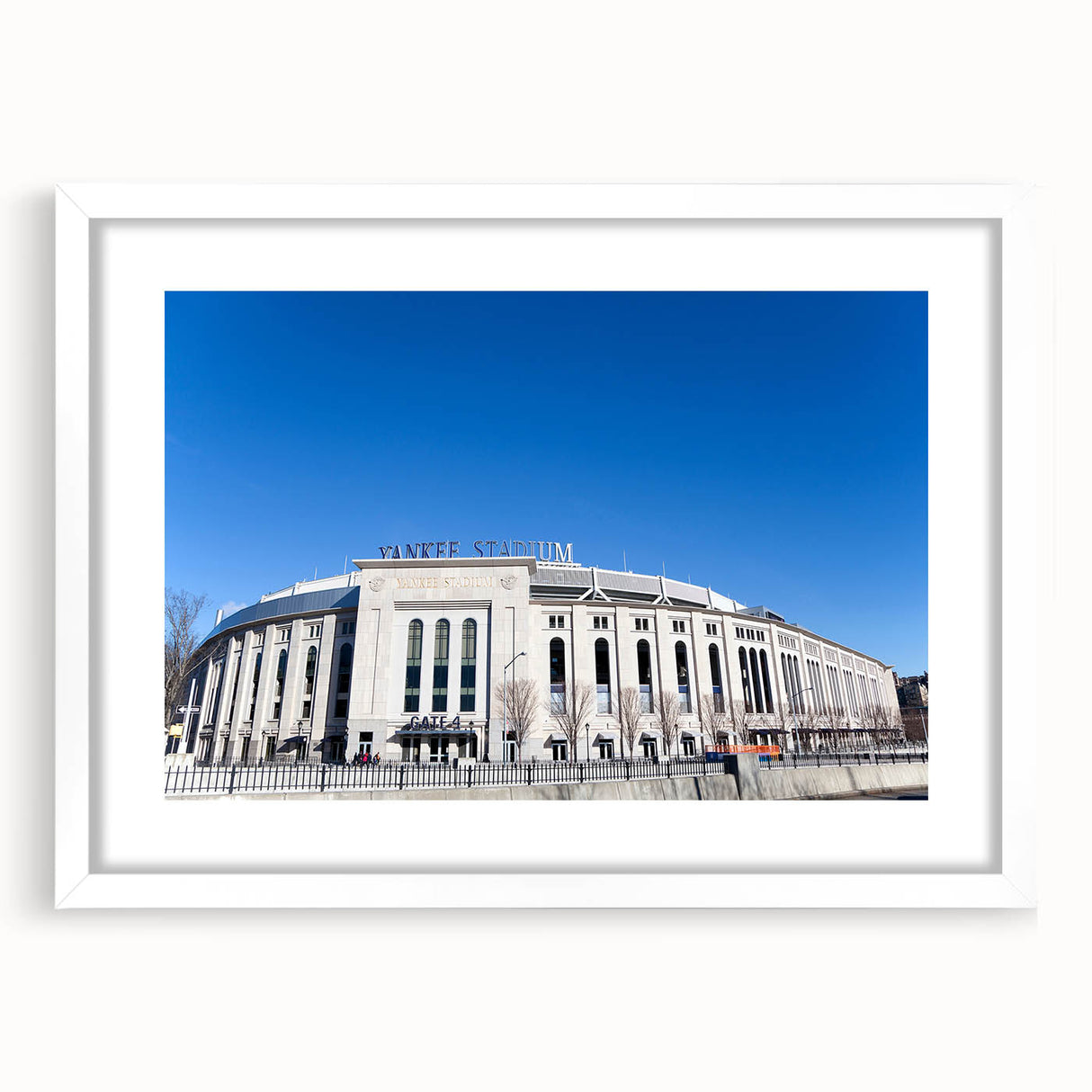 Abstract art print of New York City skyline in muted gray and blue tones, framed with a white mat.