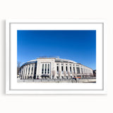 Abstract art print of New York City skyline in muted gray and blue tones, framed with a white mat.