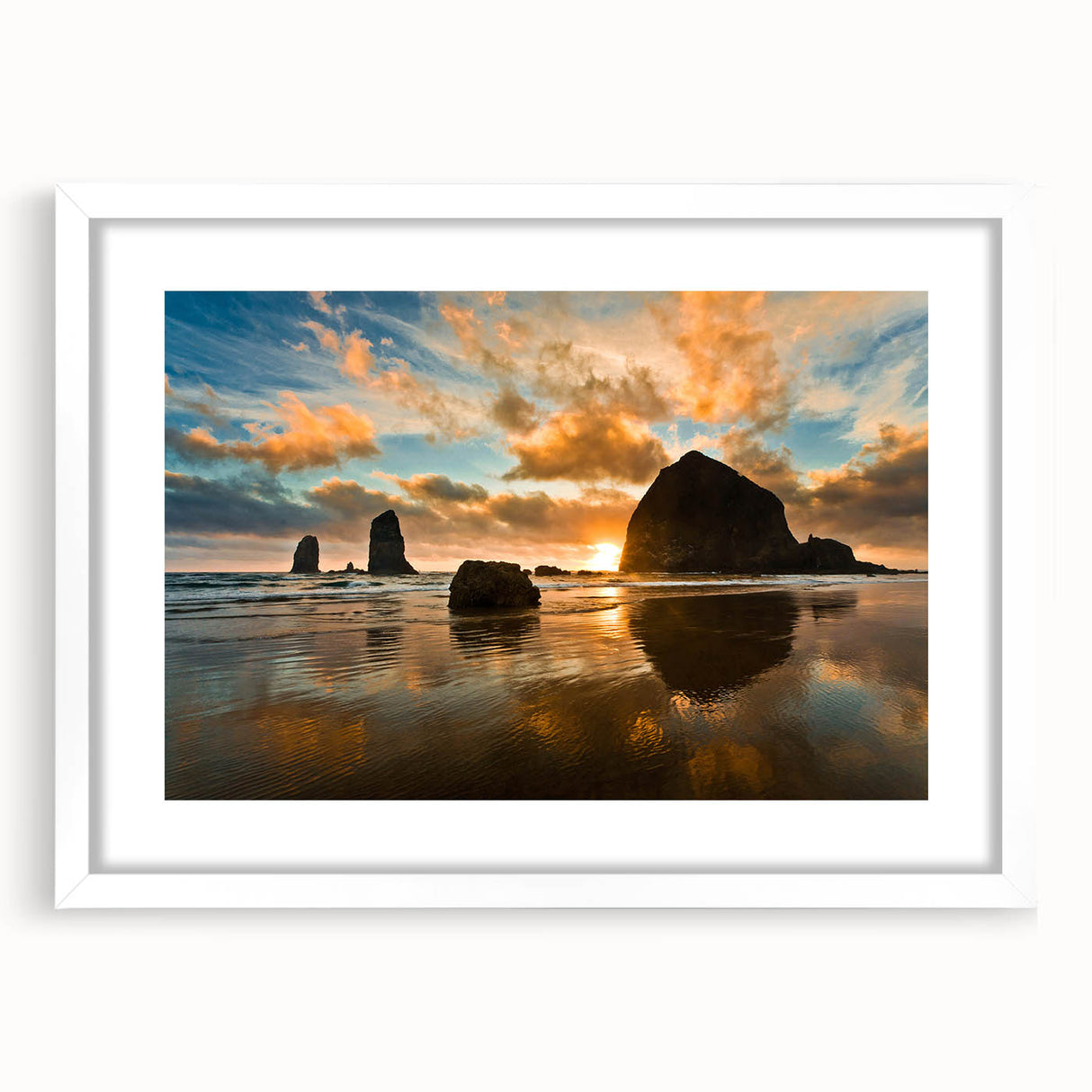 Abstract art print of Cannon Beach in muted blue and gray tones on a framed white mat.