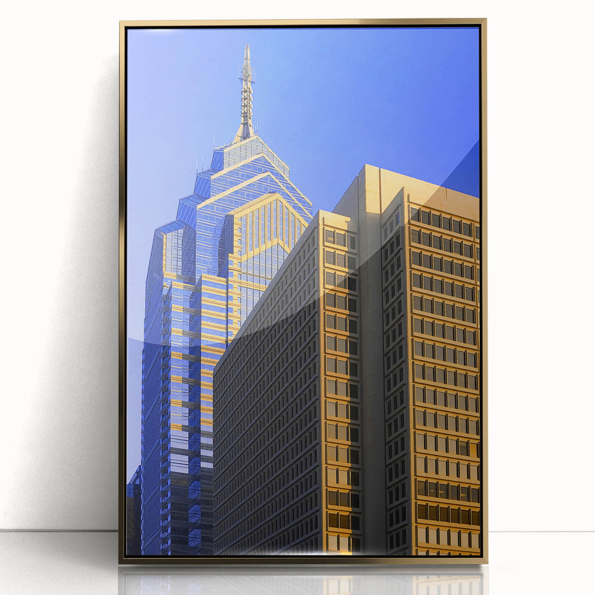 Mid-century modernist art of Philadelphia skyline in gold and black tones on a framed acrylic.