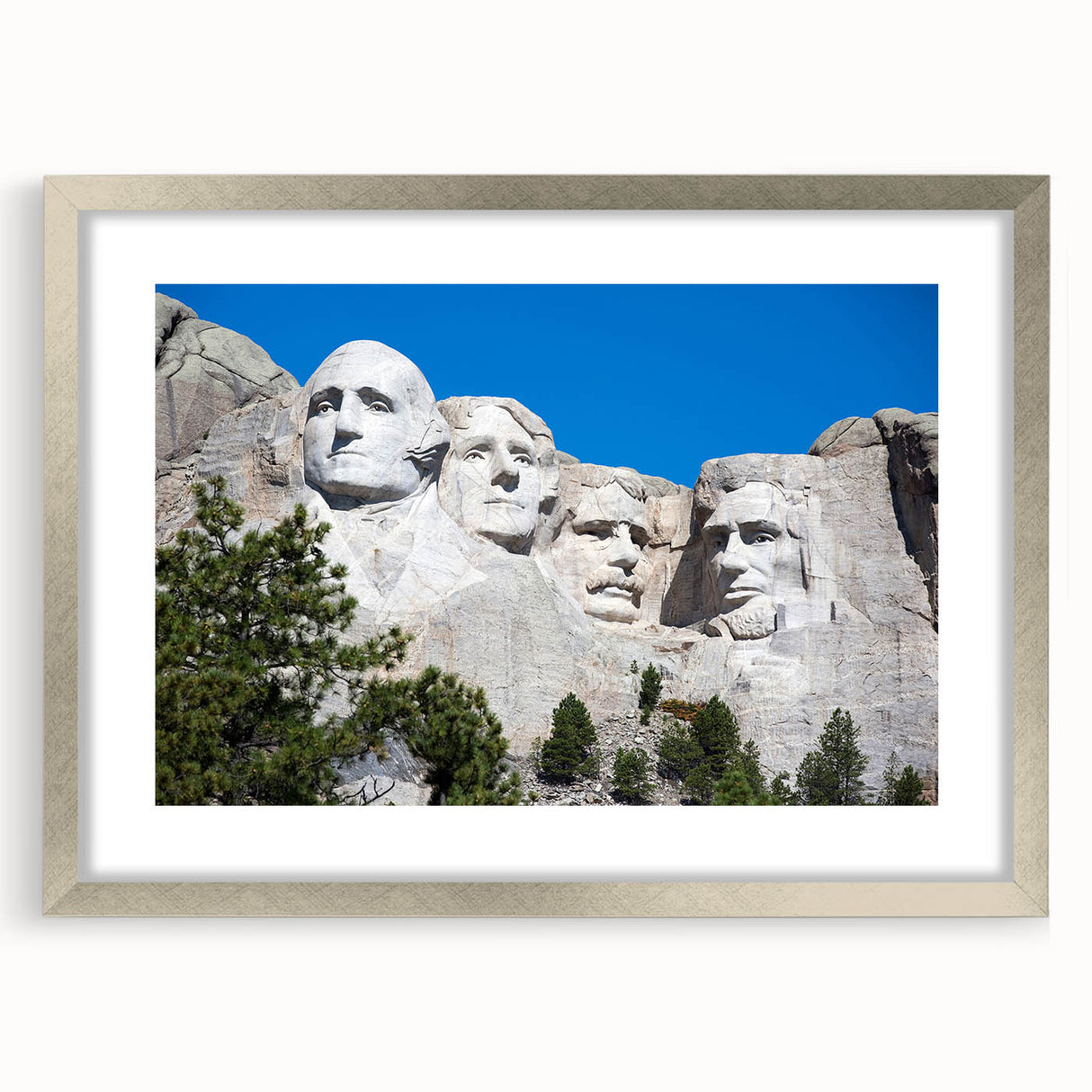 Textured art print of Mt. Rushmore in muted earth tones on a framed silver mat, suitable for bedroom art.