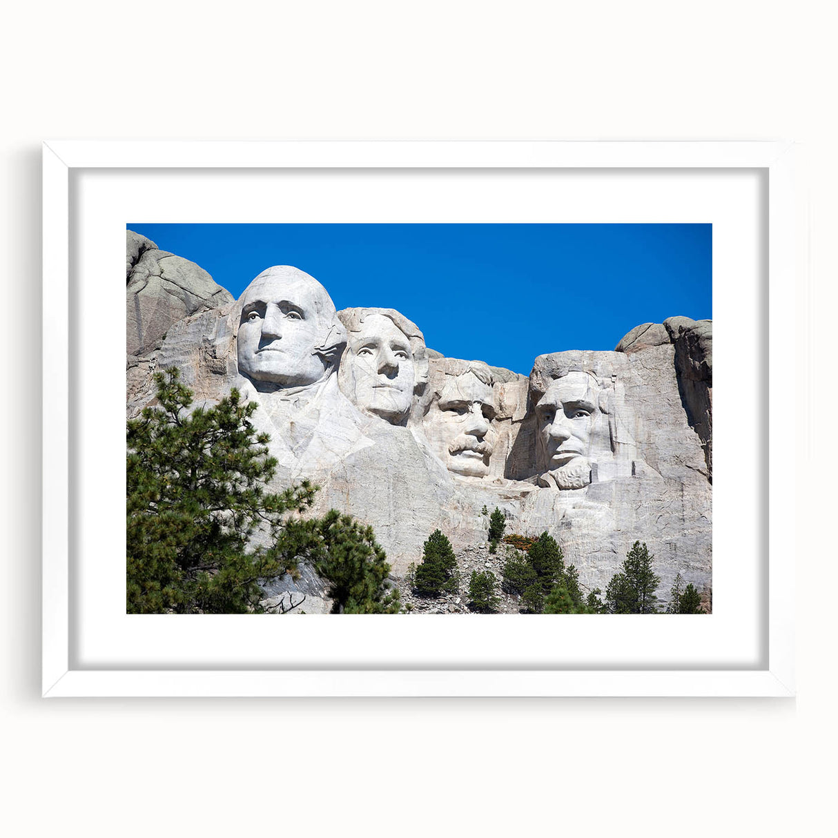 Abstract art print of Mt. Rushmore in muted earth tones, framed with a white mat, suitable for dining room decor.