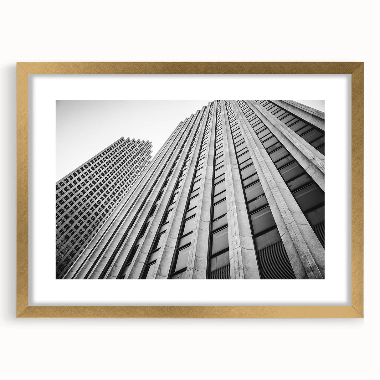Extra large abstract art print of Houston skyline, gold-framed with textured details, in muted earth tones.