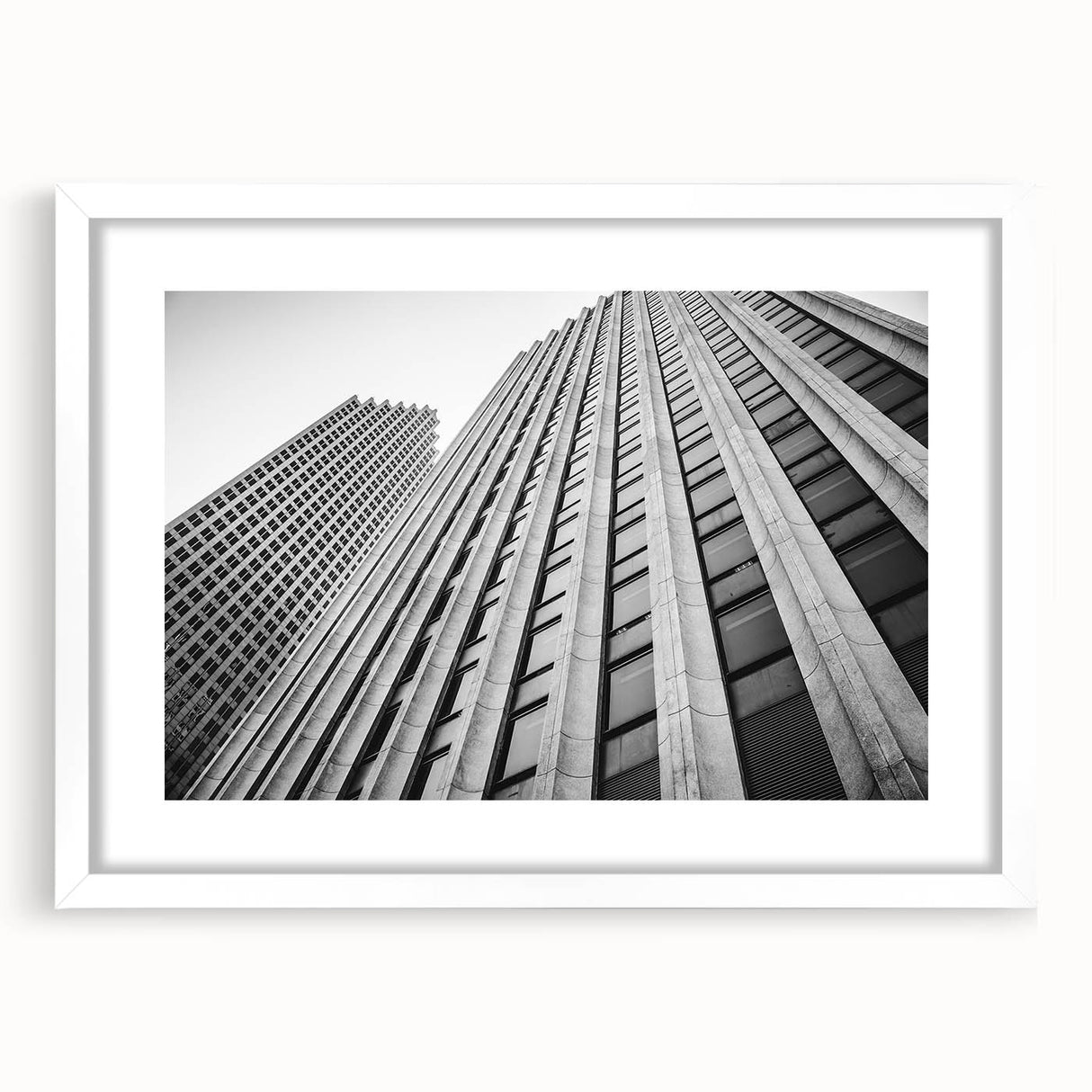 Abstract art print of Houston skyline in muted blue and gray tones on a framed white mat, ideal for dining room decor.