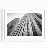 Abstract art print of Houston skyline in muted blue and gray tones on a framed white mat, ideal for dining room decor.