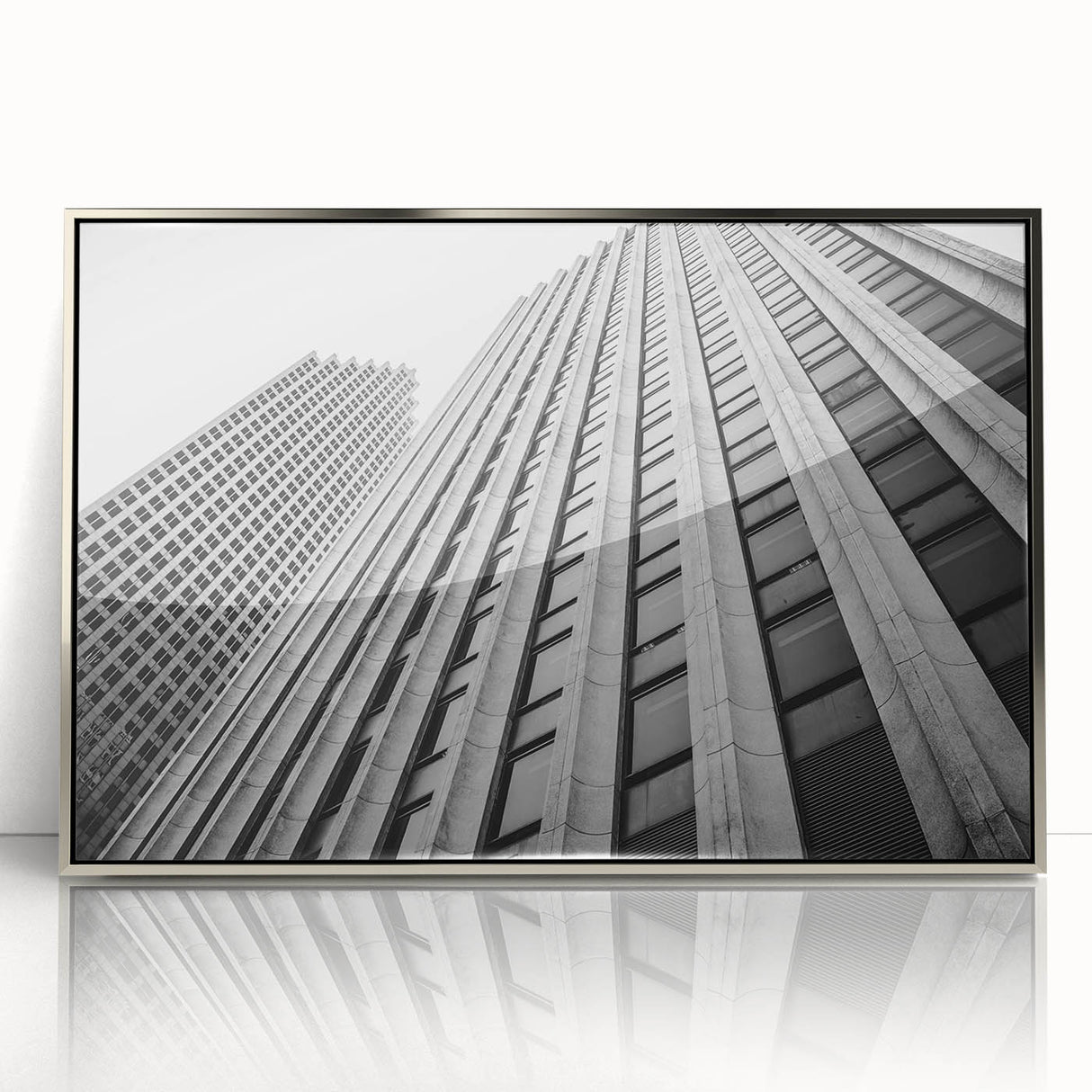 Mid-century modernist art featuring Houston skyline in muted gray and blue tones on a silver-framed acrylic print.