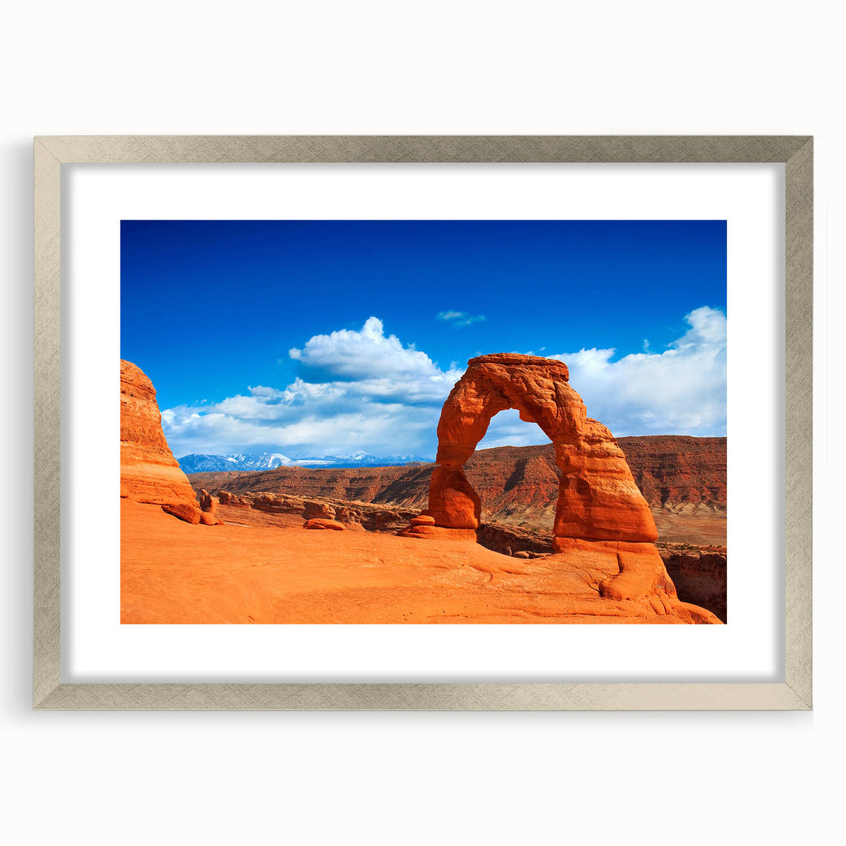 Abstract textured art of Arches National Park in muted earth tones on a silver-framed mat, suitable for bedroom decor.