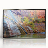 Mid-century modernist art depicting Zion National Park in vibrant earth tones on a silver-framed acrylic print.