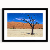 Abstract art print of an African scenery in vibrant colors on a textured, extra large canvas, framed in black.