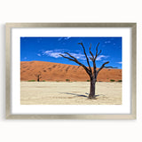 Abstract art print of an African landscape in muted earth tones on a framed canvas, suitable for dining room decor.