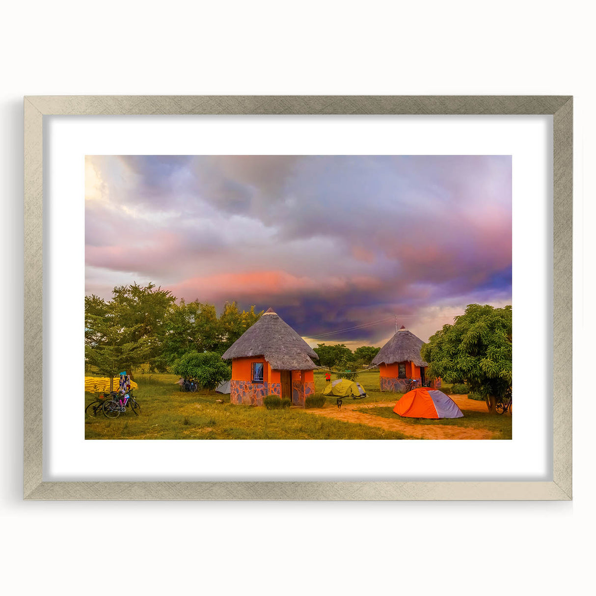 Textured abstract art print depicting a muted earth tone African landscape, framed in silver, ideal for bedroom decor.