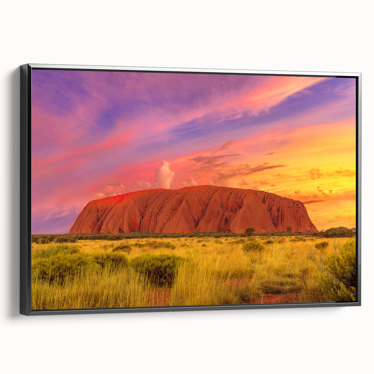 Black and white framed canvas of Ayers Rock landscape, ideal for bedroom wall decor.
