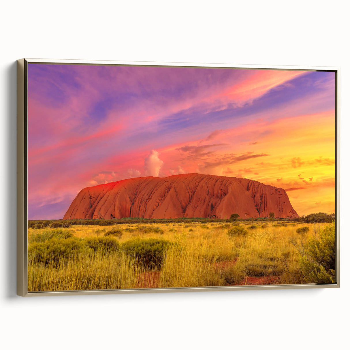 Framed canvas depicting Ayers Rock in Australia, featuring earthy tones and a vintage poster style.
