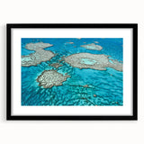 Colorful abstract art print of the Great Barrier Reef in vibrant blues and greens, framed in black.