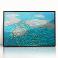 Large abstract wall art of the Great Barrier Reef in blue and green tones, framed in black acrylic.