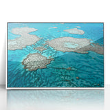 Large acrylic print of the Great Barrier Reef in soft blue and green tones, framed in white.