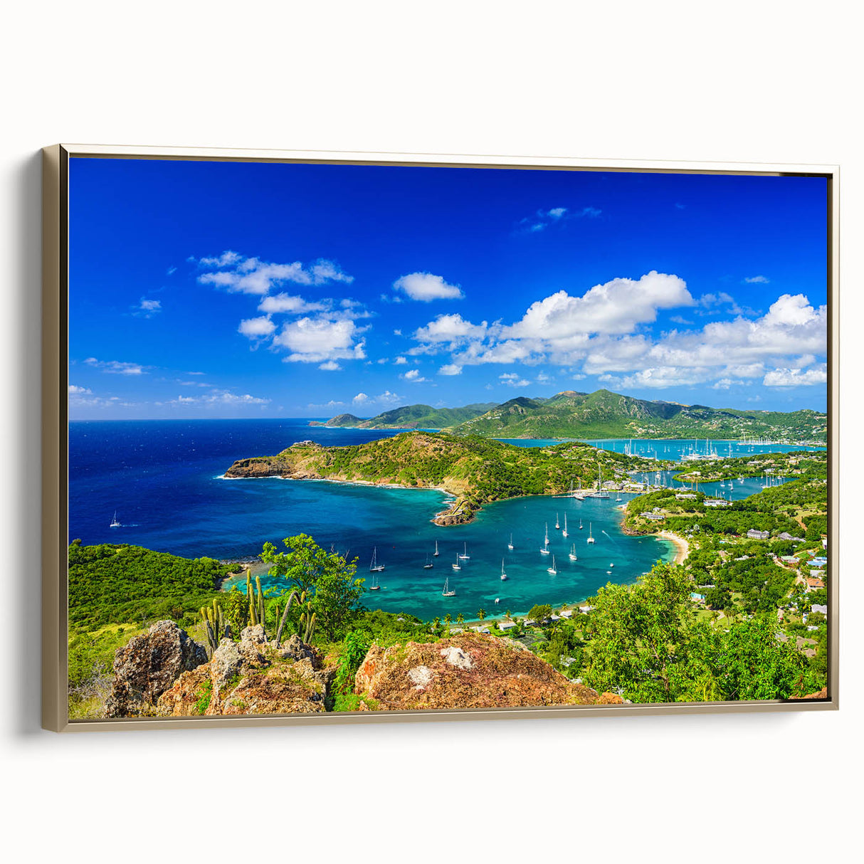 Framed canvas of a vintage-style Caribbean landscape with lush greenery and ocean, in muted gold and black tones.