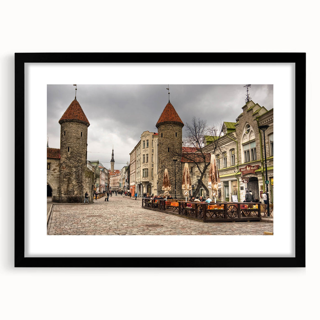 Extra large abstract art print of a colorful European scenery on textured canvas, framed in black.