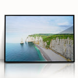 Large abstract wall art depicting the Normandy coast in muted blues and grays, framed in black acrylic.
