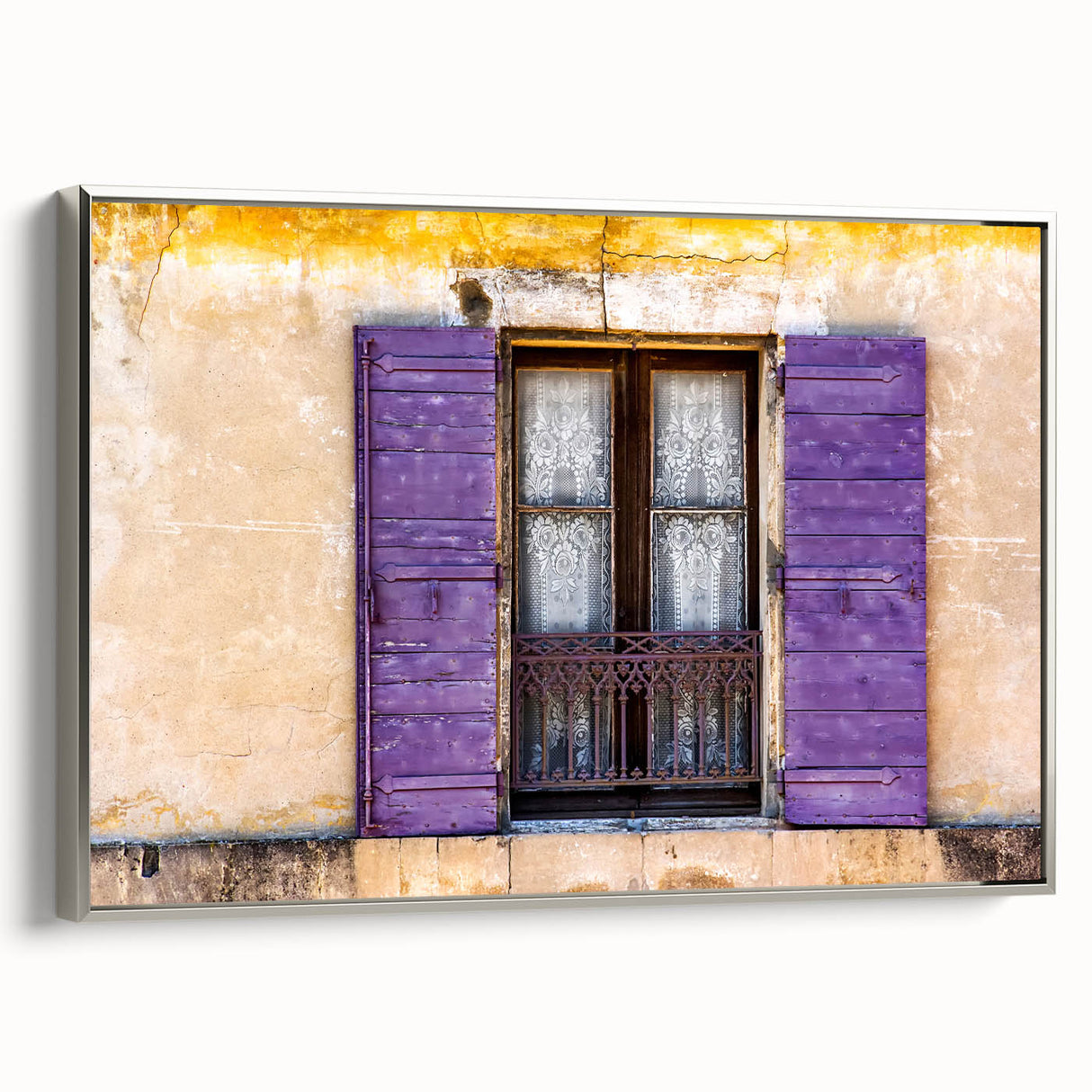 Framed canvas of a vintage-style landscape painting depicting a scenic French village, featuring a palette of soft pastels.