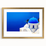 Abstract art print of Santorini with blue and white tones on a framed gold mat, ideal for dining room decor.