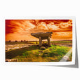 Rolled print of an Irish landscape featuring green fields and a distant castle, in muted earth tones.
