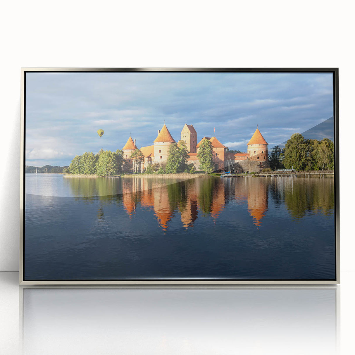 Large art print of a European Lithuanian scenery in muted earth tones, framed in silver acrylic.