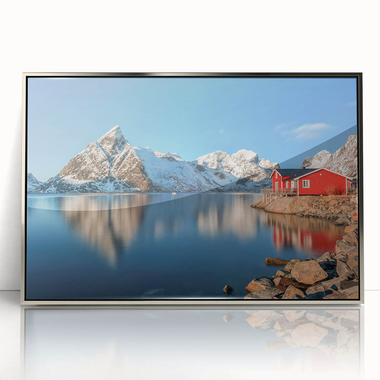 Large art print of a Norwegian landscape in muted green and blue tones, framed in silver acrylic.