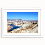 Abstract art print depicting a Middle Eastern landscape in muted earth tones, framed with a white mat.
