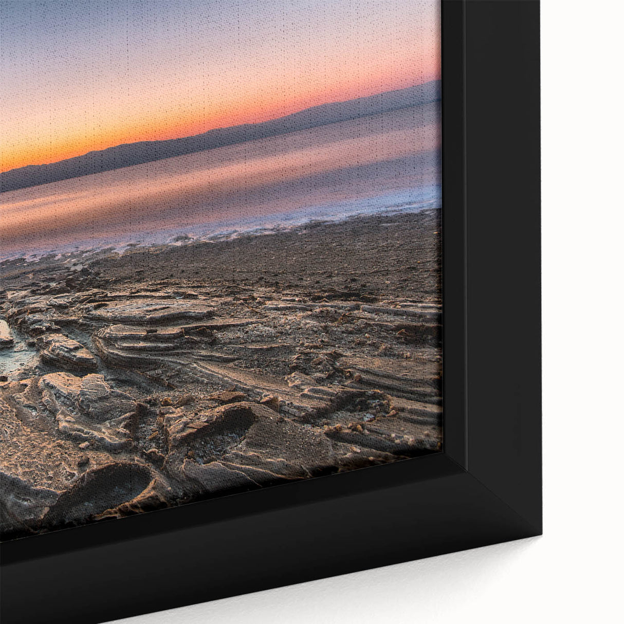 Black wall art featuring a textured close-up of the Dead Sea in vibrant colors on a framed canvas.