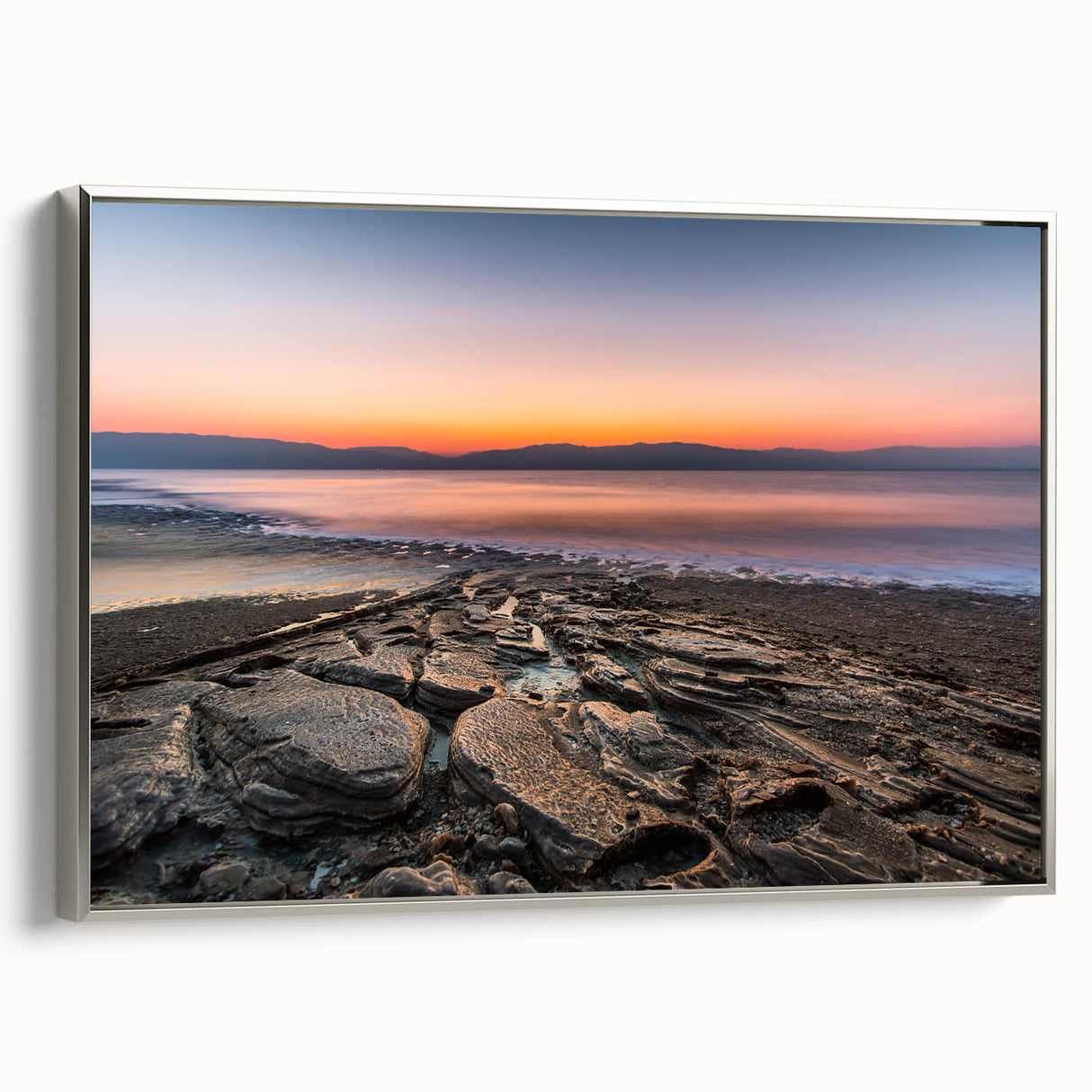 Framed canvas of a vintage-style landscape painting depicting the Dead Sea with muted earth tones.