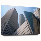 Large abstract wall art of Tel Aviv skyline in muted blue and gray tones on acrylic glass.