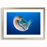 Textured abstract art print featuring oceanic blue tones on a silver-framed mat, ideal for bedroom wall decor.
