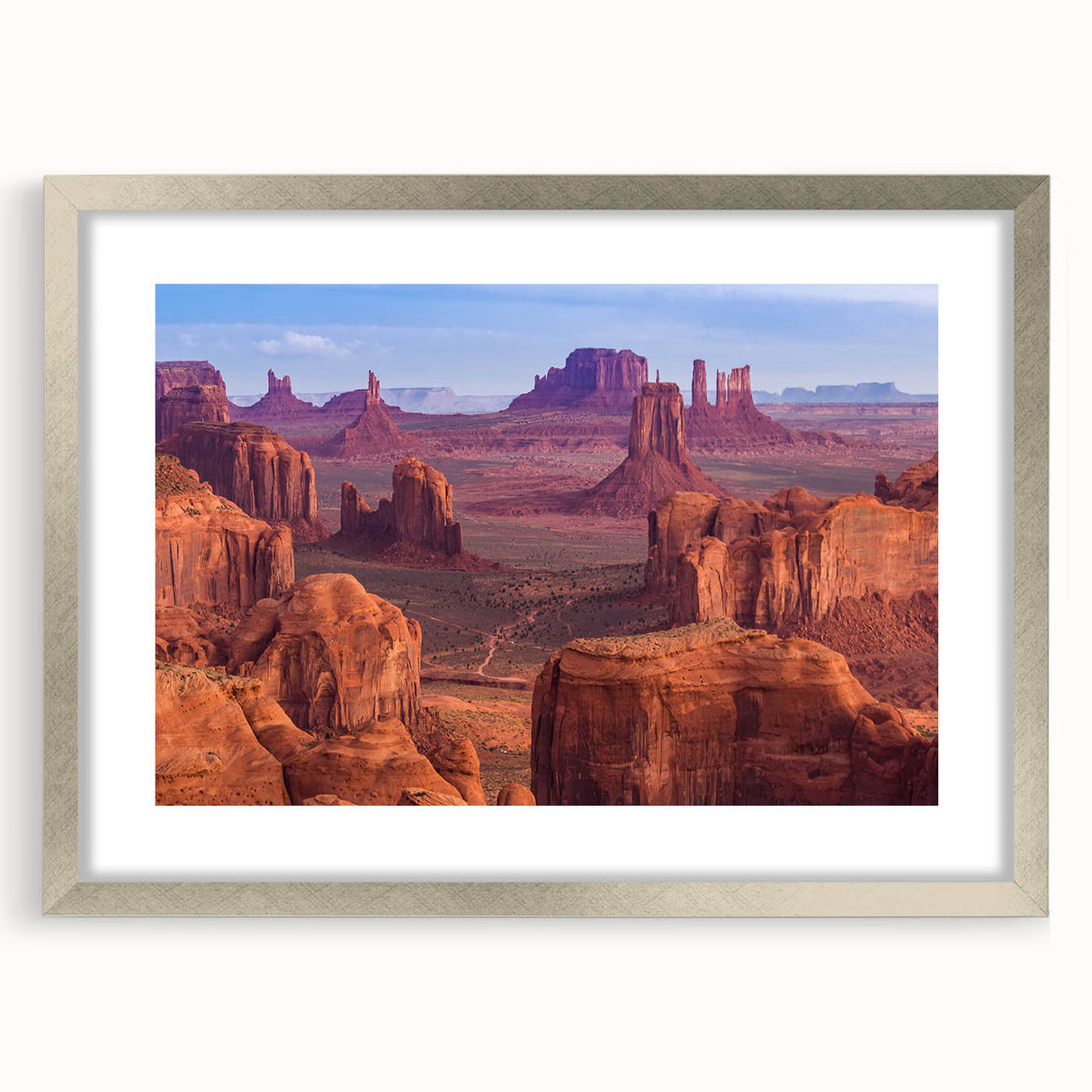 Textured art print of the Grand Canyon in earthy tones on a silver-framed mat, suitable for bedroom decor.