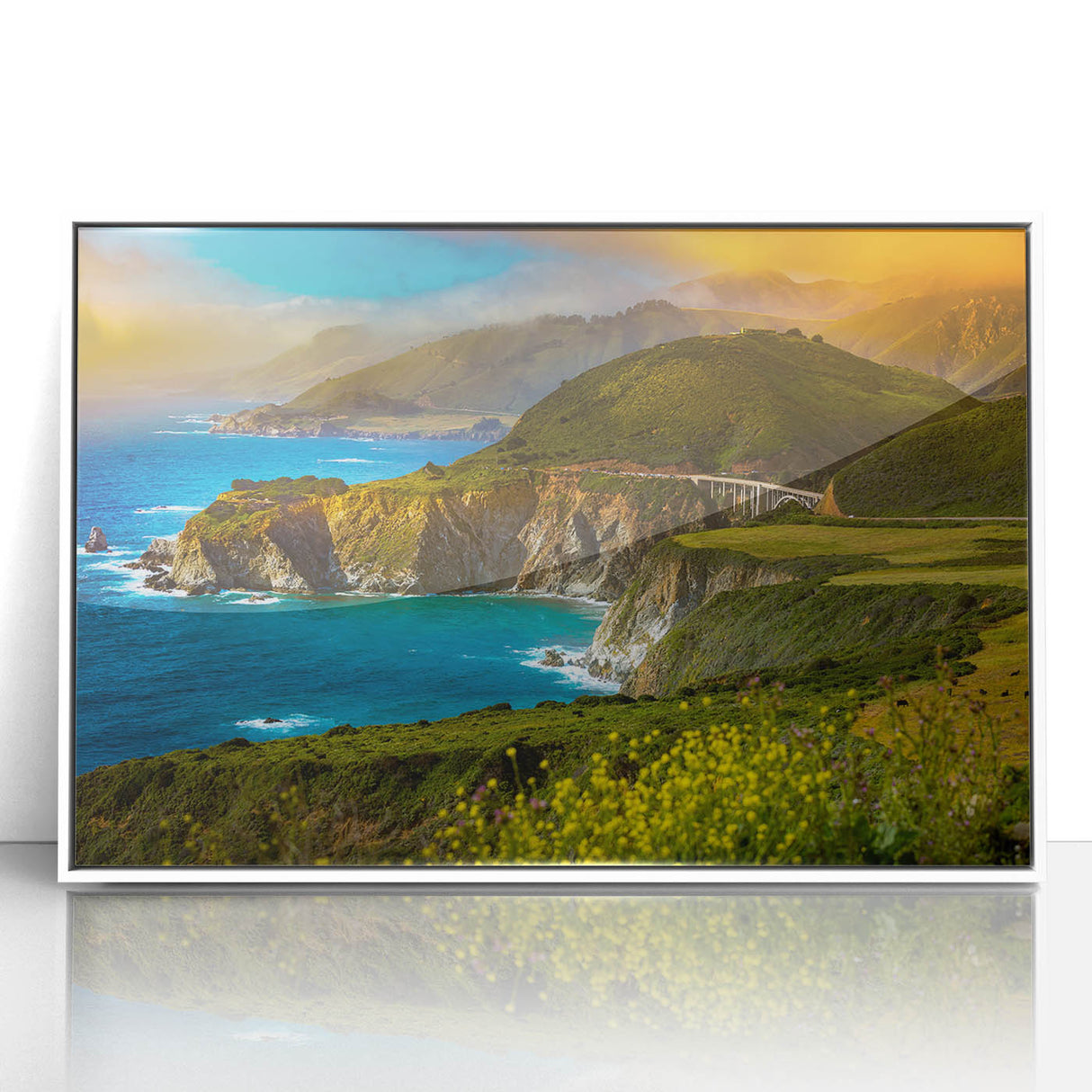 Acrylic print of Big Sur coastline in muted earth tones, framed in white, suited for modern nursery decor.