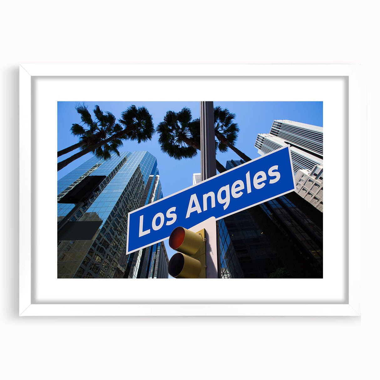 Abstract art print of Los Angeles skyline in muted gray and blue tones, framed with a white mat.